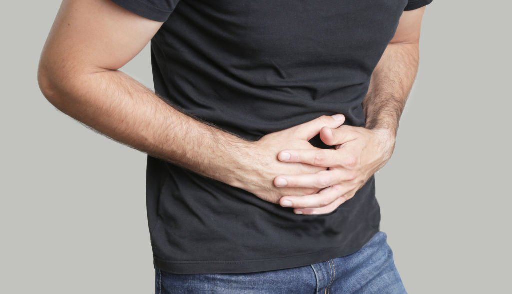 Man having painful stomach ache, chronic gastritis or abdomen bloating